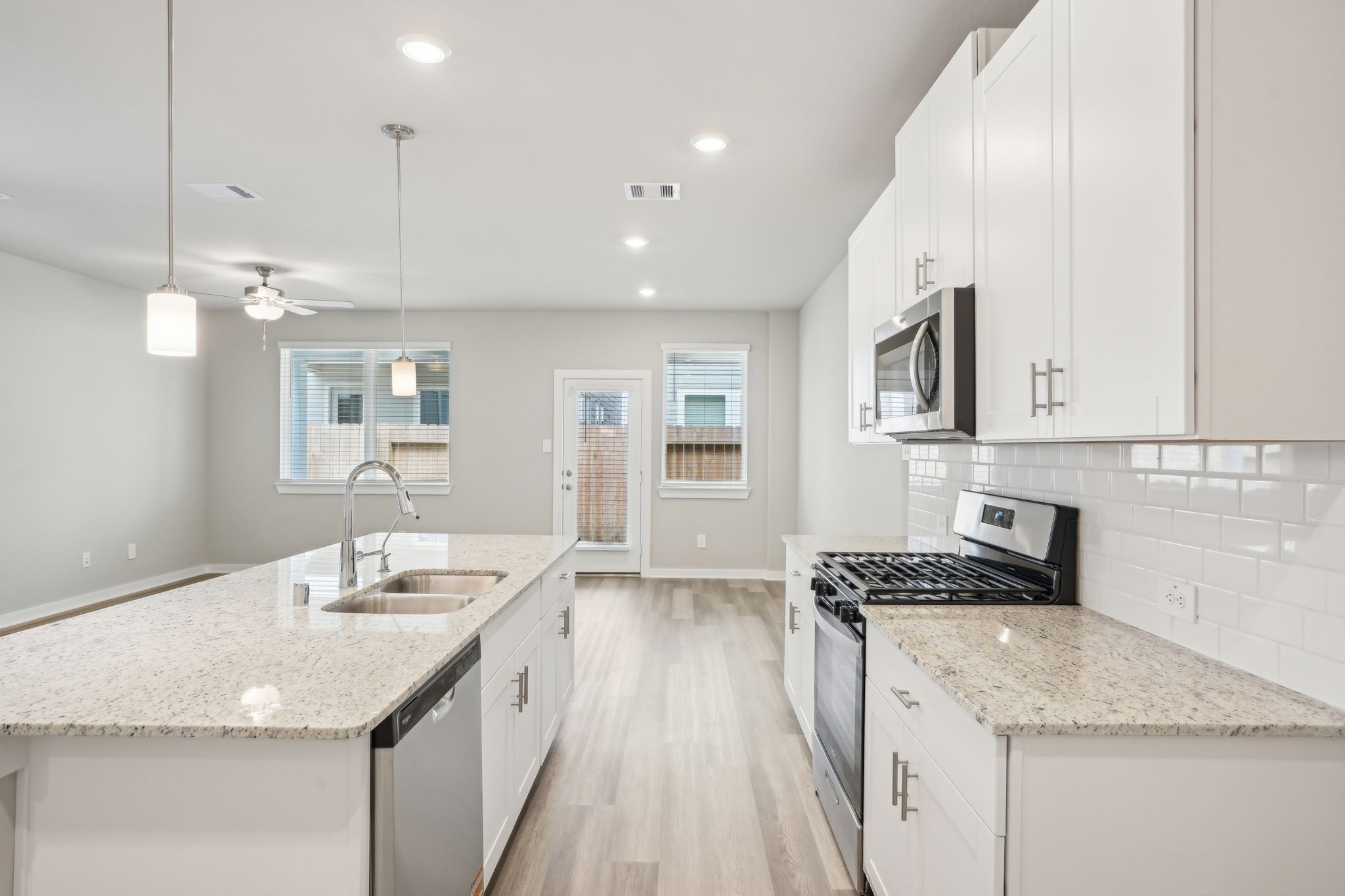 3119 Quiet Sunset Drive Houston, TX 77080 - Photo 5 of 46 a kitchen with stainless steel appliances granite countertop a sink stove and cabinets
