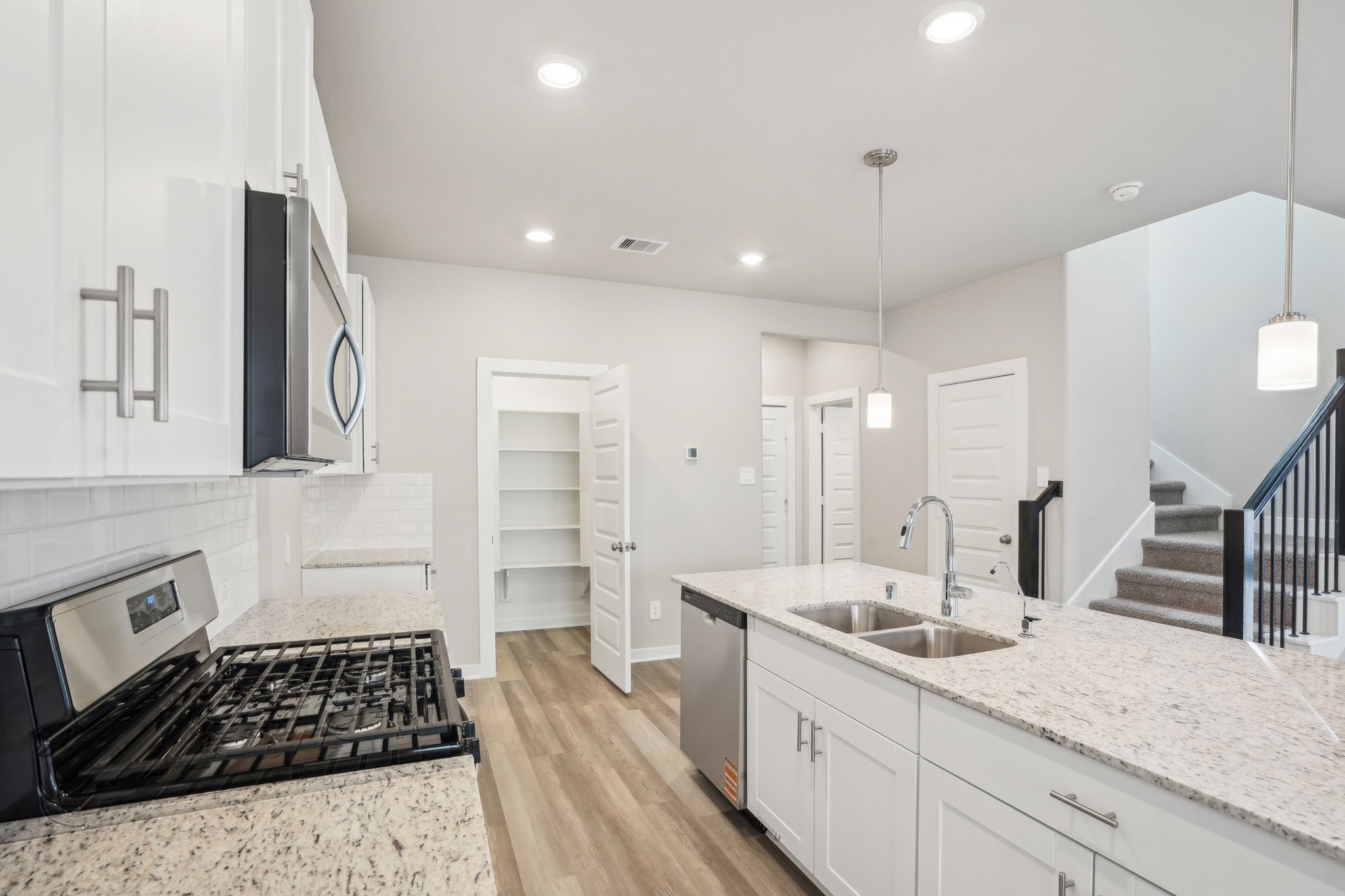 3119 Quiet Sunset Drive Houston, TX 77080 - Photo 7 of 46 a kitchen with a sink and a stove top oven