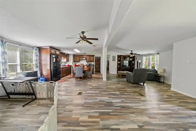 a view of a livingroom with furniture and a flat screen tv