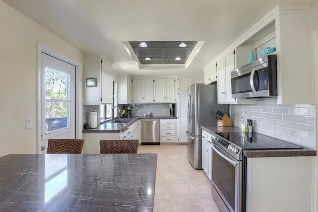 a view of a dining room with furniture water view and windows
