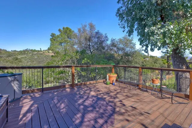 a view of a porch with furniture and wooden floor