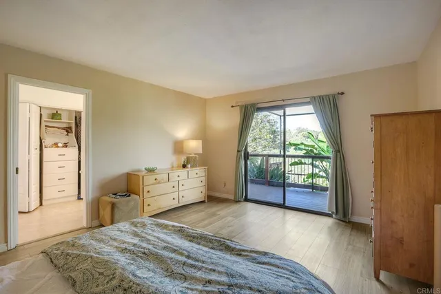 a view of a livingroom with wooden floor and a flat screen tv