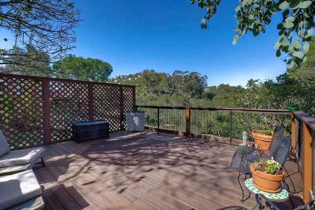 a view of backyard with wooden fence