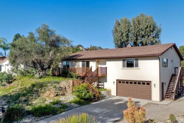 a front view of a house with a yard and sitting area