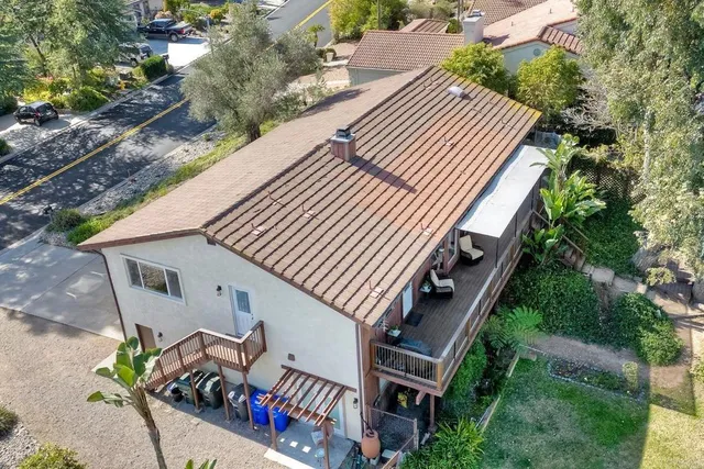 a view of chair and tables in the patio next to a yard