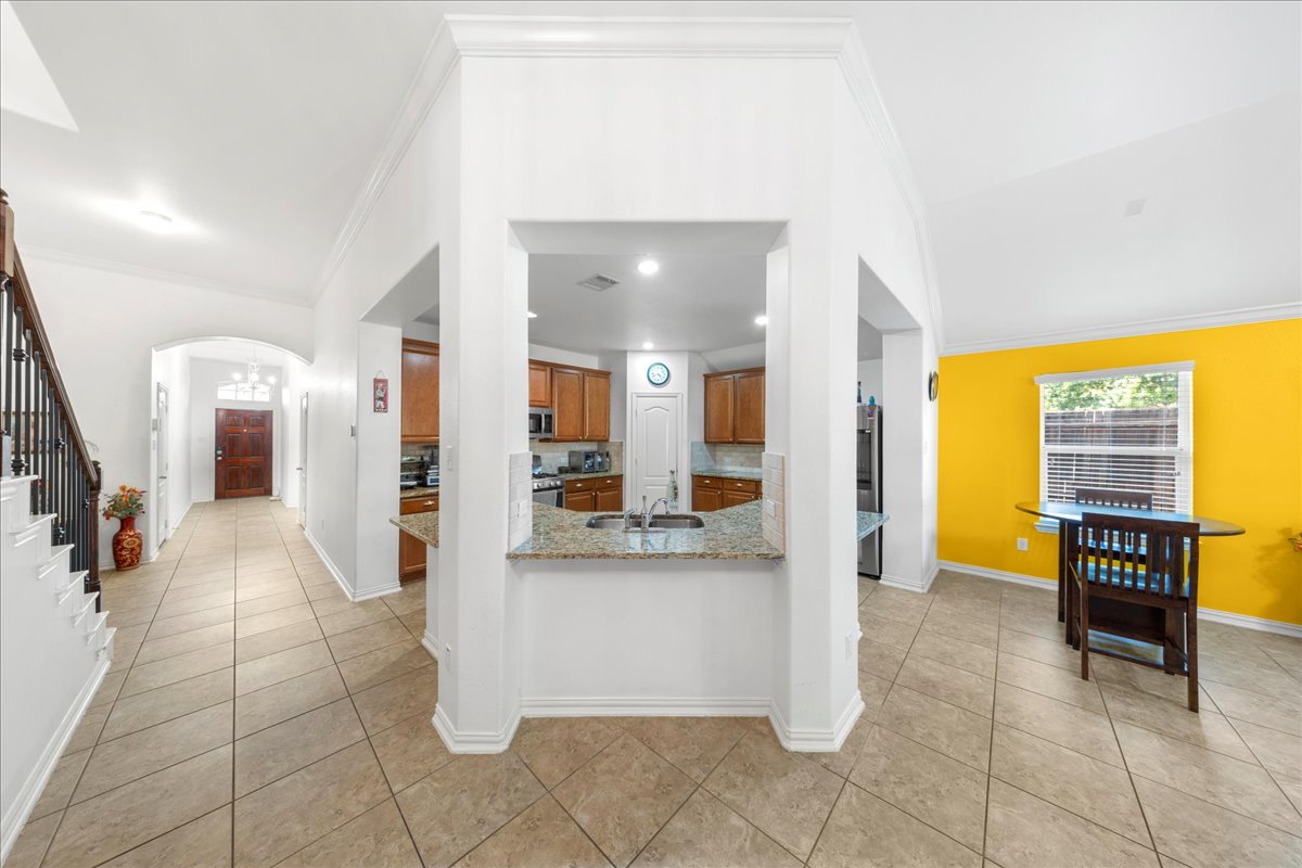 349 Razzmatazz Trail Buda, TX 78610 - Photo 21 of 40 a view of a kitchen with furniture and a living room