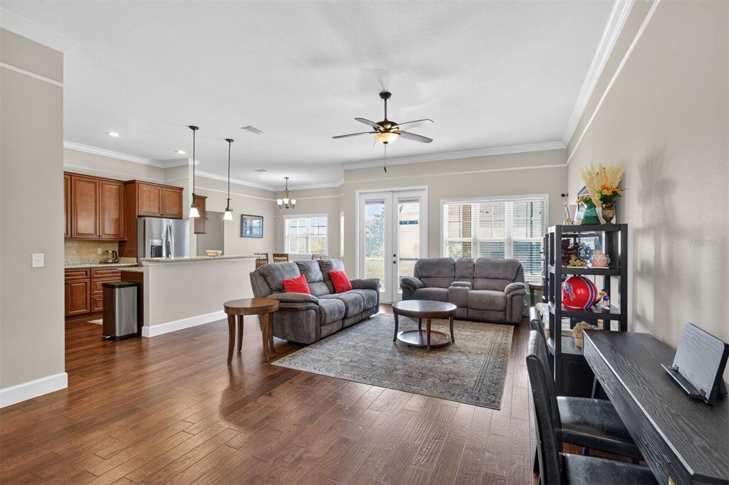 11949 Northwest 13 Road Gainesville, FL 32606 - Photo 20 of 46 a living room with furniture kitchen area and a wooden floor