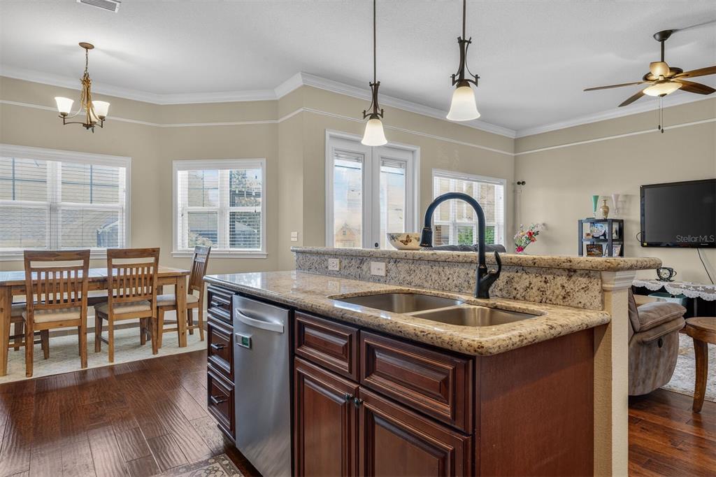 11949 Northwest 13 Road Gainesville, FL 32606 - Photo 23 of 46 a kitchen with center island a sink appliances and wooden floor