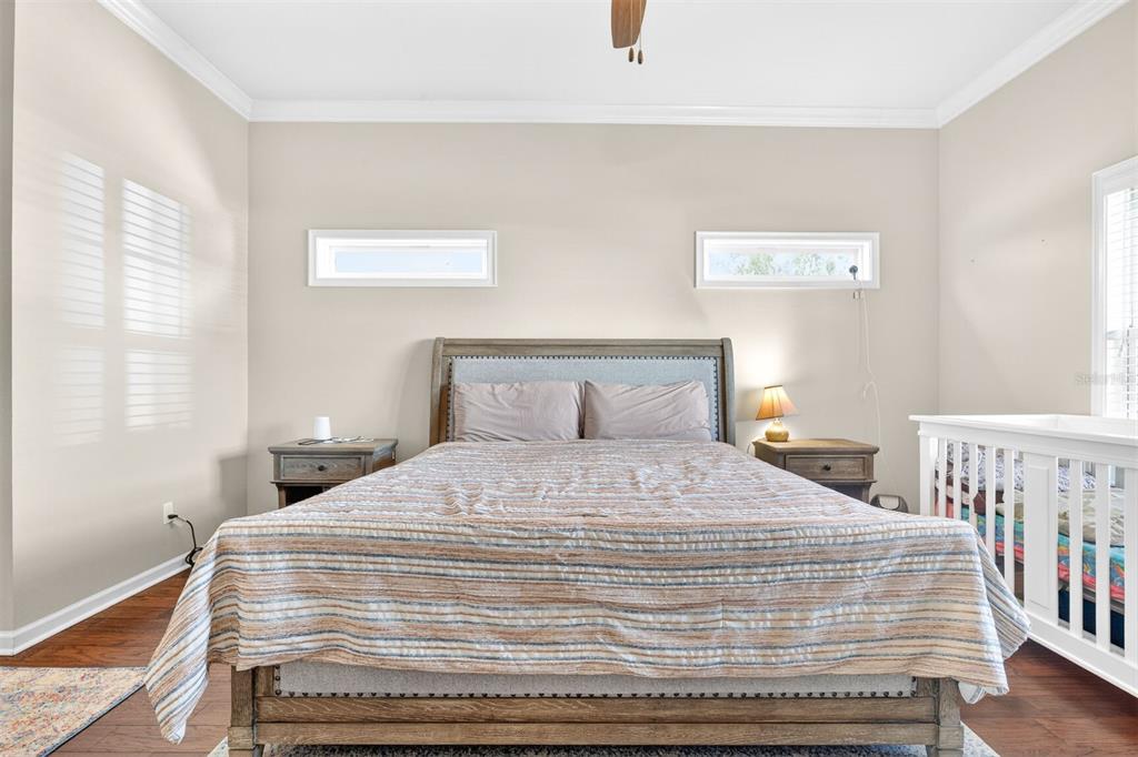 11949 Northwest 13 Road Gainesville, FL 32606 - Photo 27 of 46 a bedroom with a bed and wooden floor