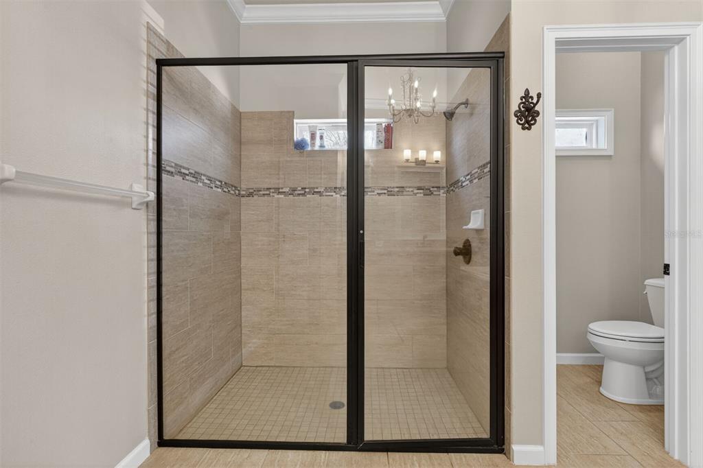 11949 Northwest 13 Road Gainesville, FL 32606 - Photo 31 of 46 a bathroom with a glass shower door