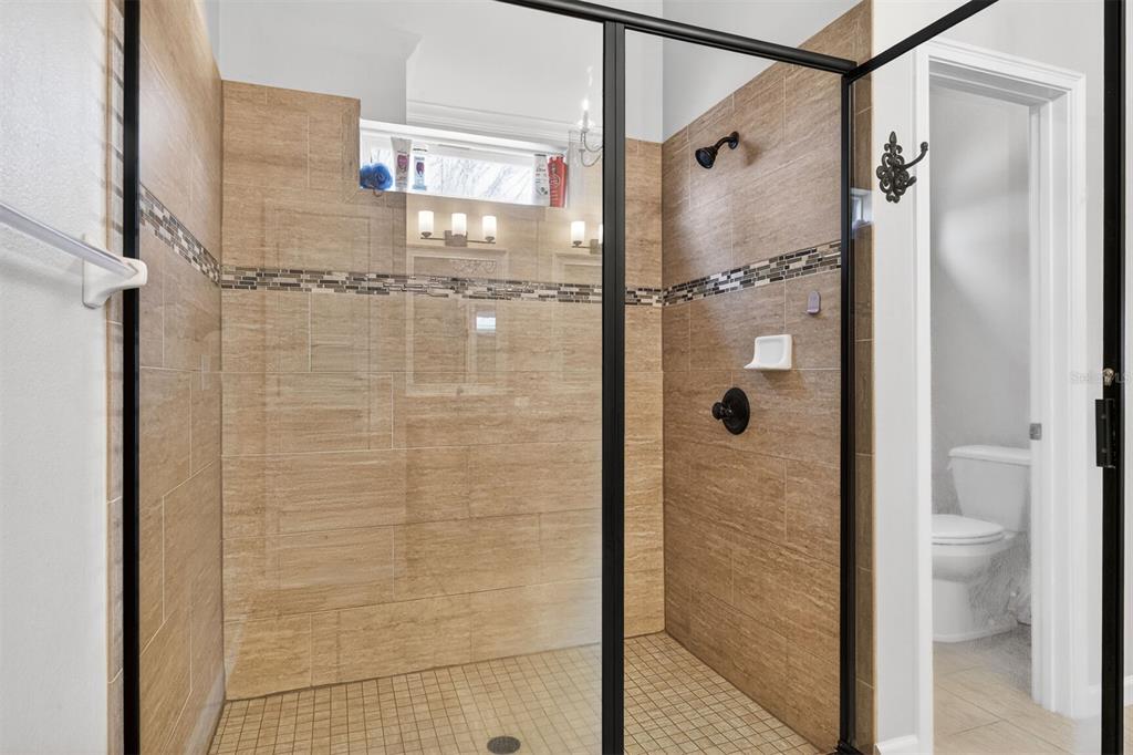 11949 Northwest 13 Road Gainesville, FL 32606 - Photo 32 of 46 a bathroom with a glass shower door