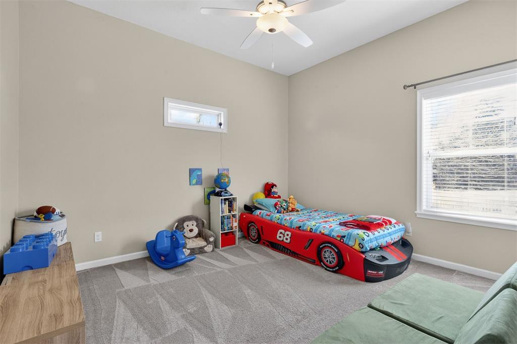 11949 Northwest 13 Road Gainesville, FL 32606 - Photo 33 of 46 a bedroom with a bed and a chandelier