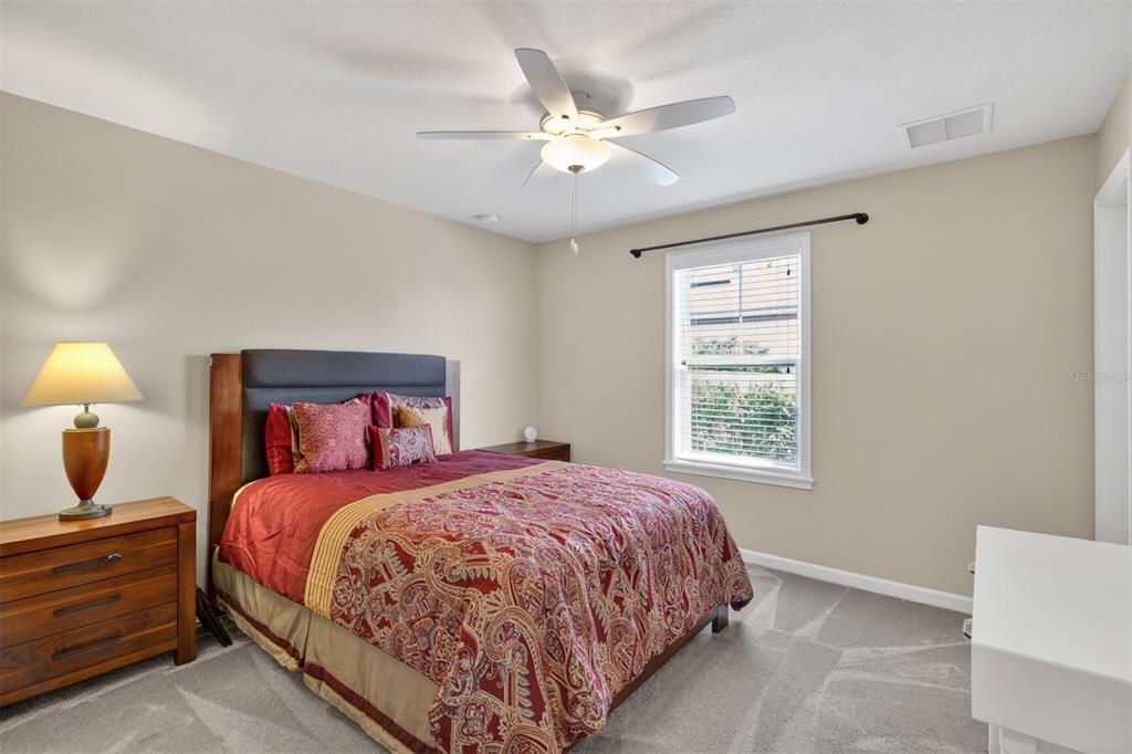 11949 Northwest 13 Road Gainesville, FL 32606 - Photo 36 of 46 a bedroom with a bed and a chandelier