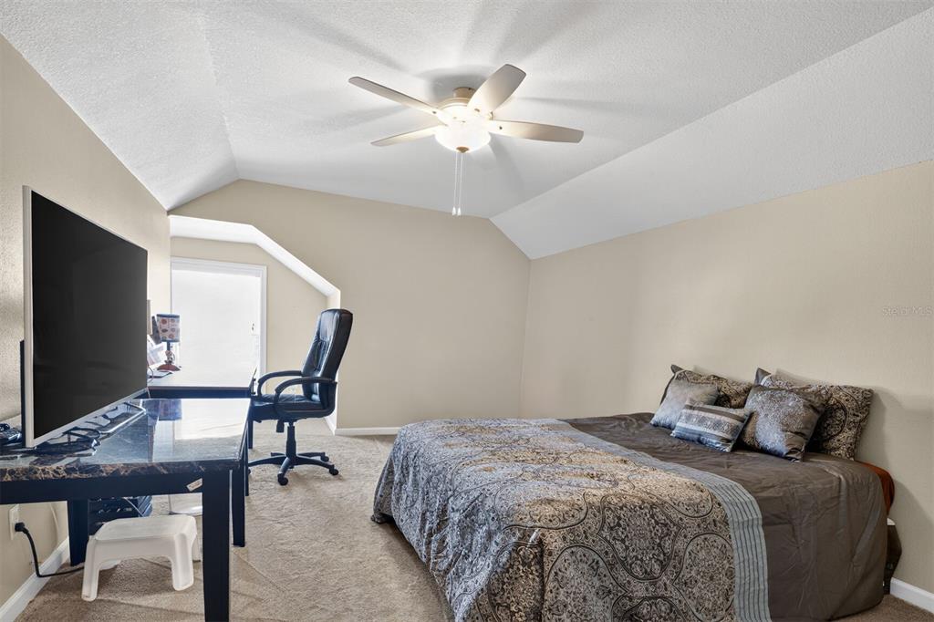 11949 Northwest 13 Road Gainesville, FL 32606 - Photo 39 of 46 a bedroom with a bed and a chandelier