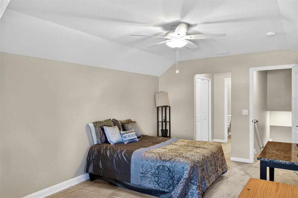 11949 Northwest 13 Road Gainesville, FL 32606 - Photo 40 of 46 a bed room with a bed and a chandelier