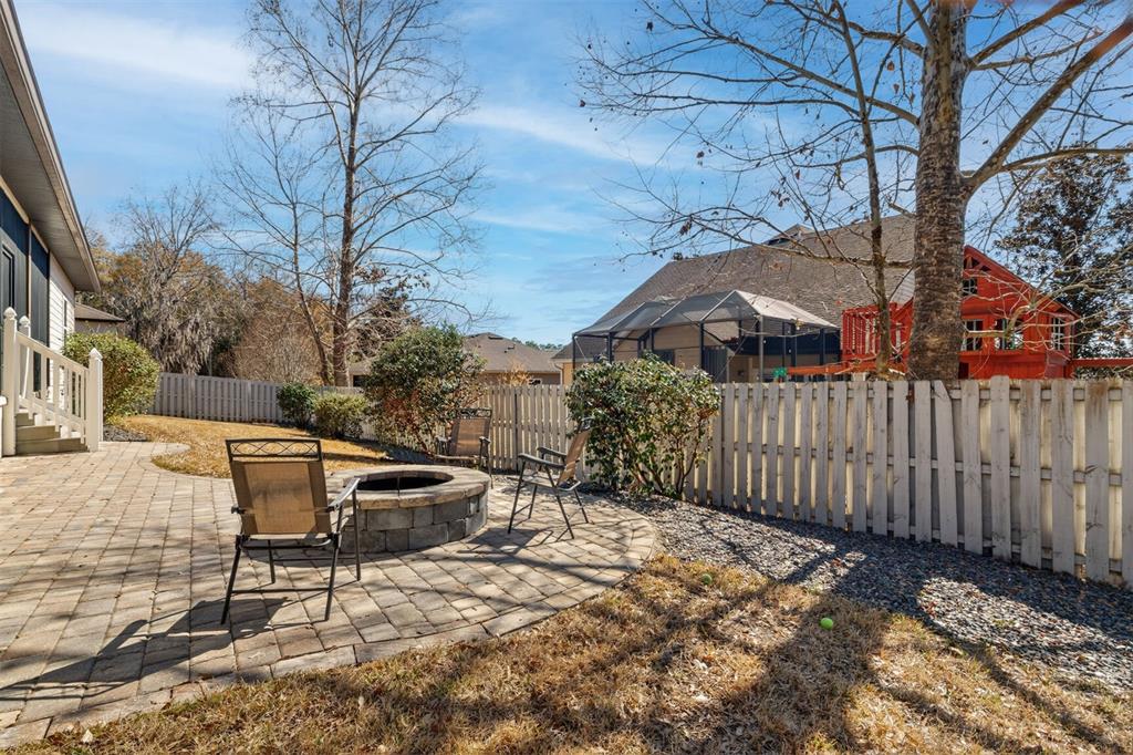 11949 Northwest 13 Road Gainesville, FL 32606 - Photo 5 of 46 a backyard of a house with table and chairs