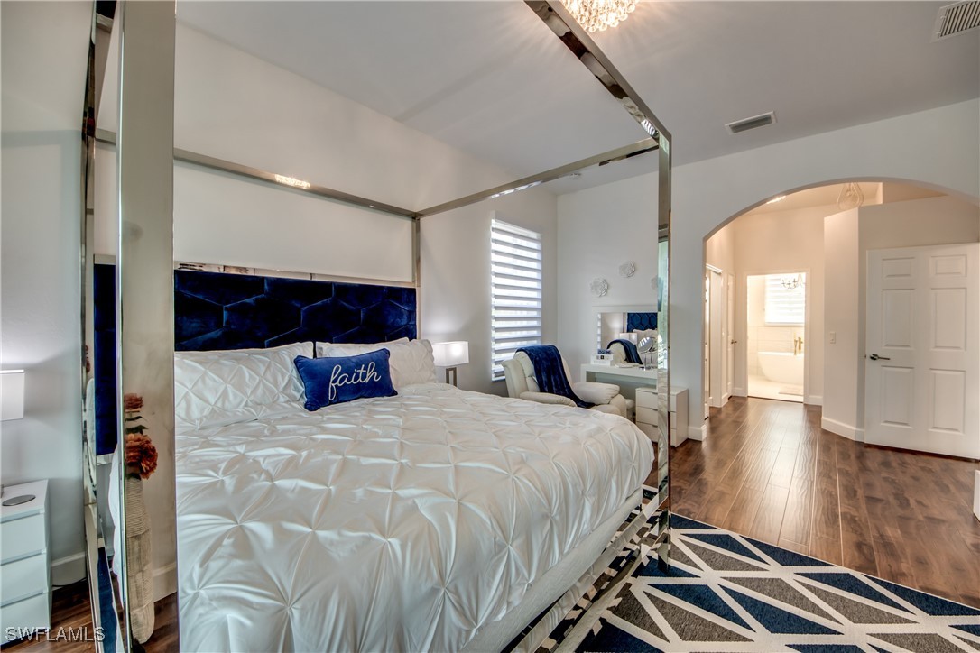 2703 Southwest 43rd Terrace Cape Coral, FL 33914 - Photo 20 of 50 a bedroom with a bed and a mirror