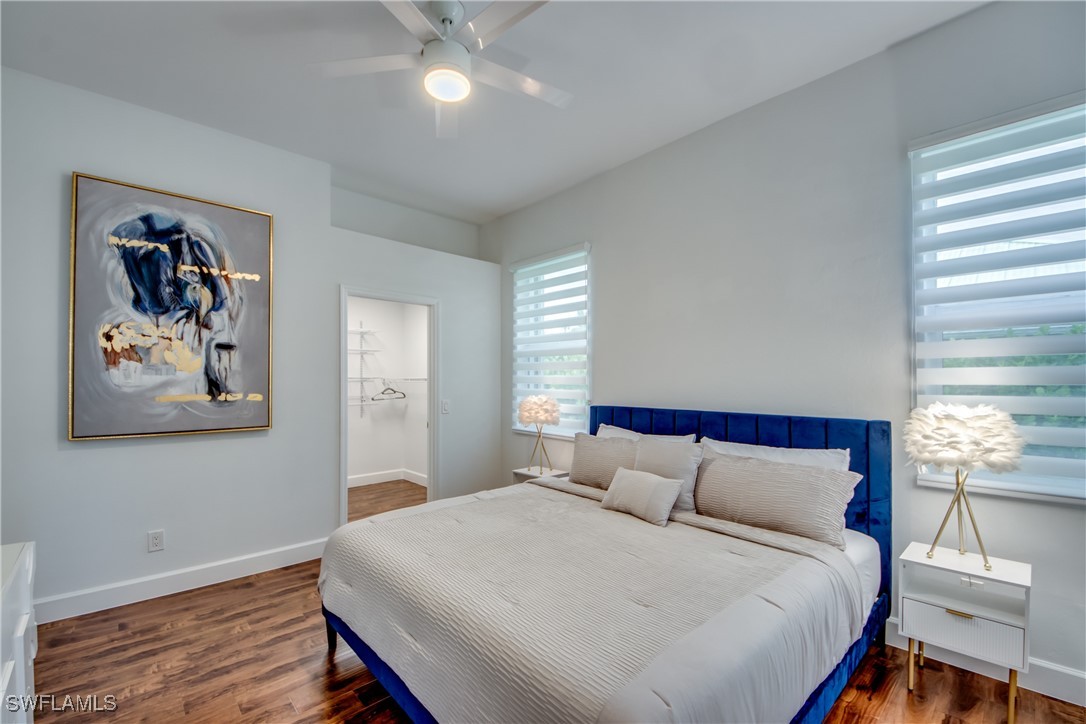 2703 Southwest 43rd Terrace Cape Coral, FL 33914 - Photo 24 of 50 a bedroom with a large bed and a chandelier