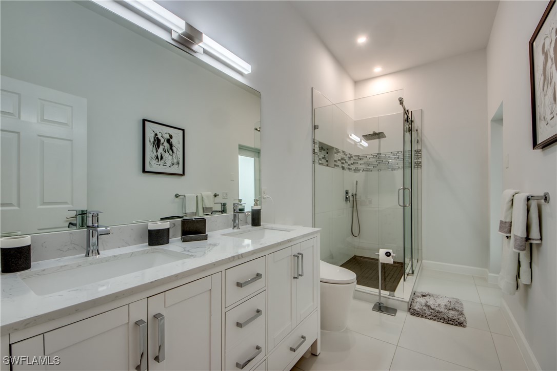 2703 Southwest 43rd Terrace Cape Coral, FL 33914 - Photo 26 of 50 a bathroom with a double vanity sink mirror double and shower
