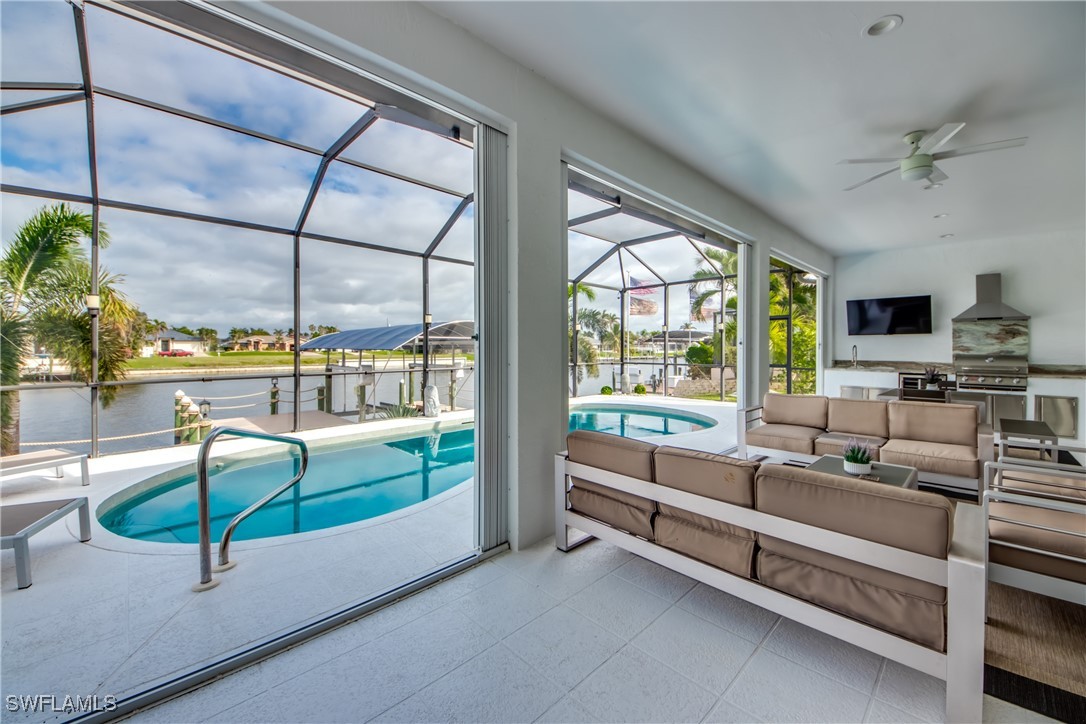 2703 Southwest 43rd Terrace Cape Coral, FL 33914 - Photo 34 of 50 a reading room with furniture and a floor to ceiling window