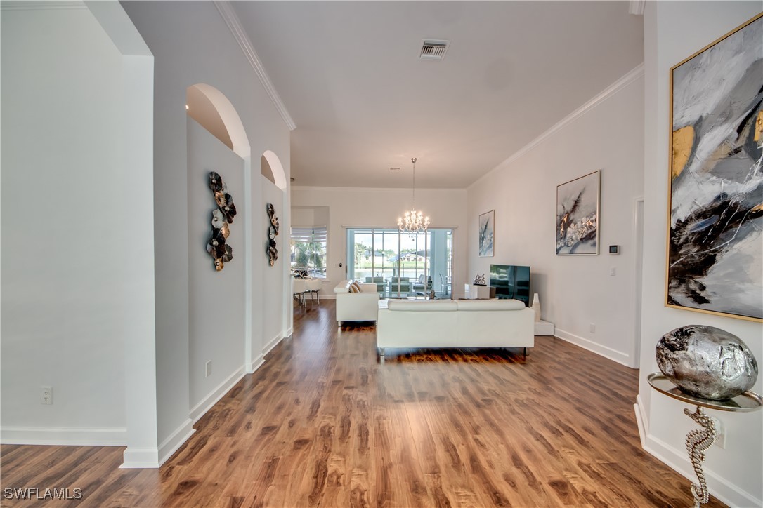 2703 Southwest 43rd Terrace Cape Coral, FL 33914 - Photo 4 of 50 a living room with furniture and wooden floor