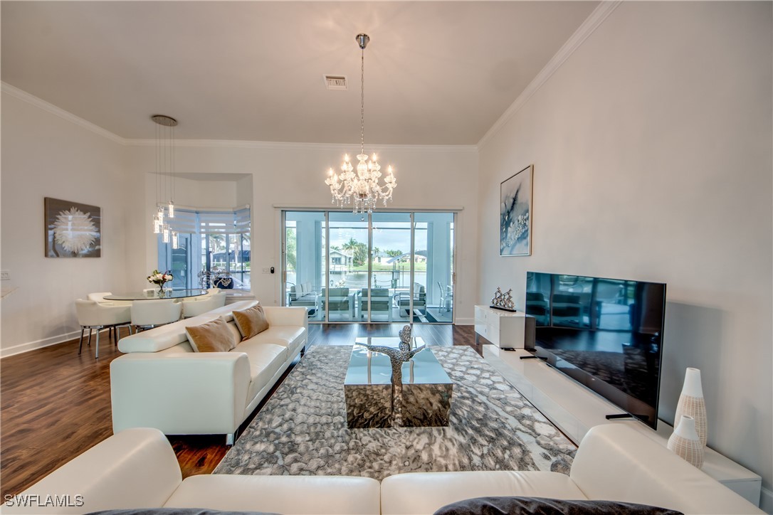2703 Southwest 43rd Terrace Cape Coral, FL 33914 - Photo 5 of 50 a living room with furniture and a fireplace