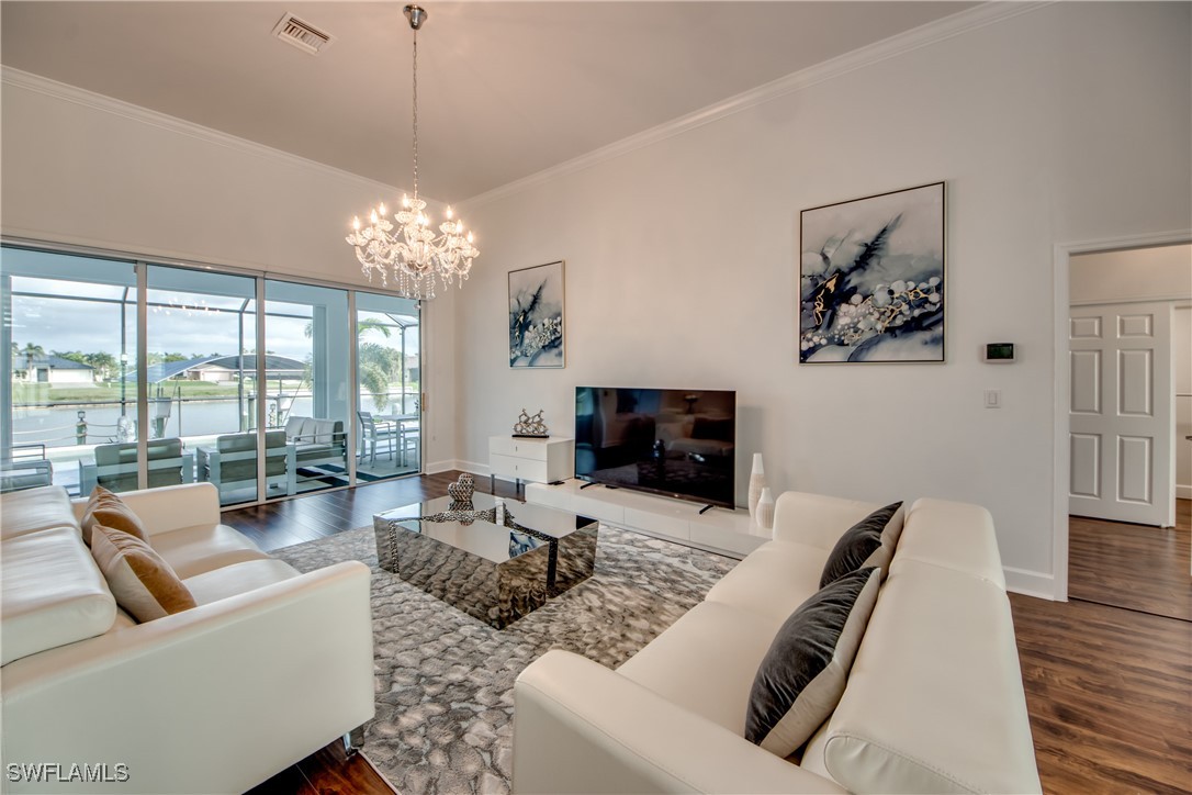 2703 Southwest 43rd Terrace Cape Coral, FL 33914 - Photo 6 of 50 a living room with furniture and a flat screen tv
