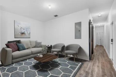 a living room with furniture and wooden floor