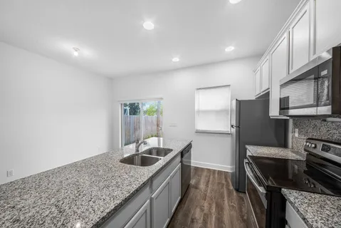 a kitchen with granite countertop a sink and granite counter tops
