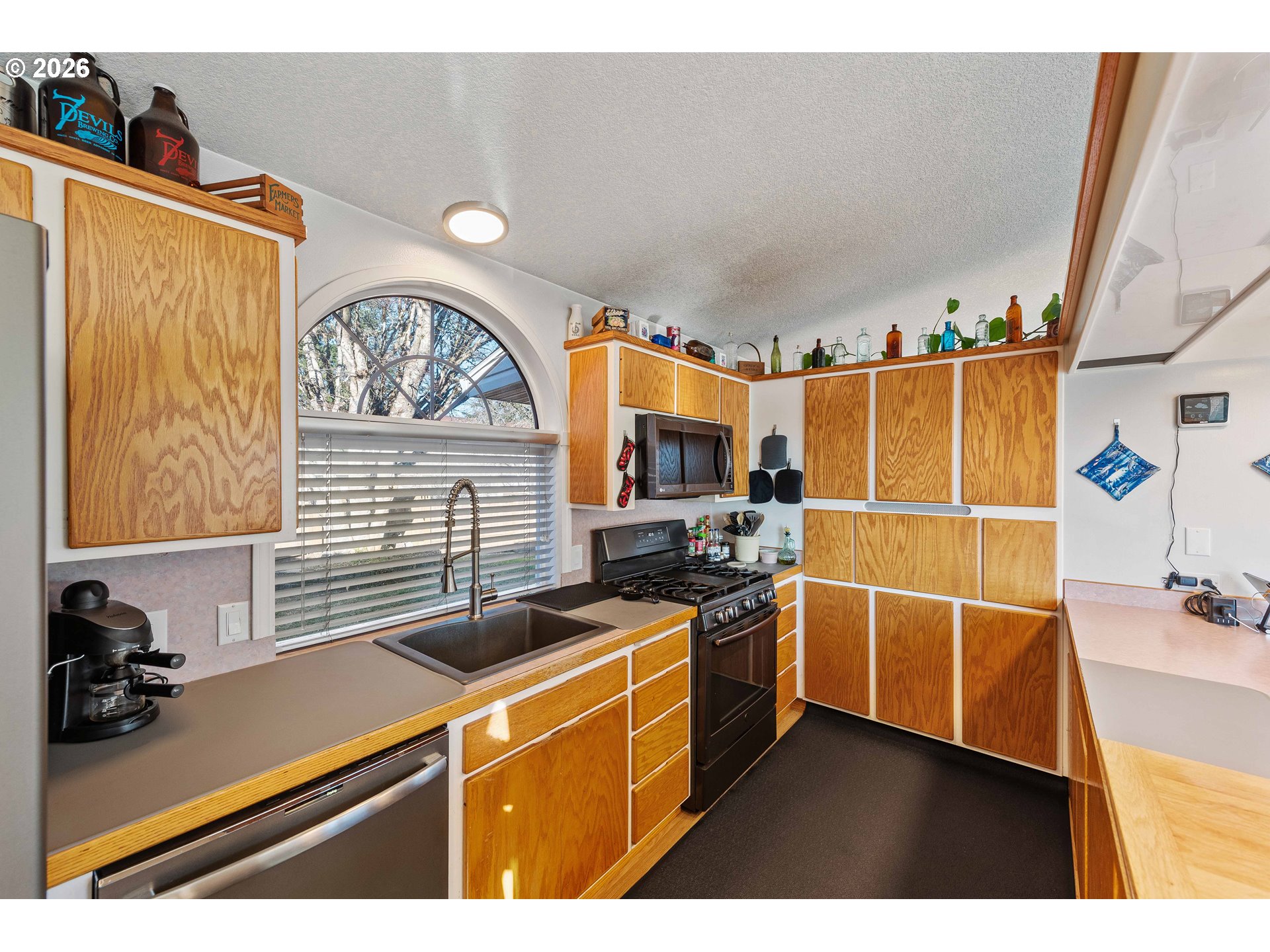770 18th Avenue Coos Bay, OR 97420 - Photo 20 of 48 a kitchen with stainless steel appliances a stove a sink and a refrigerator