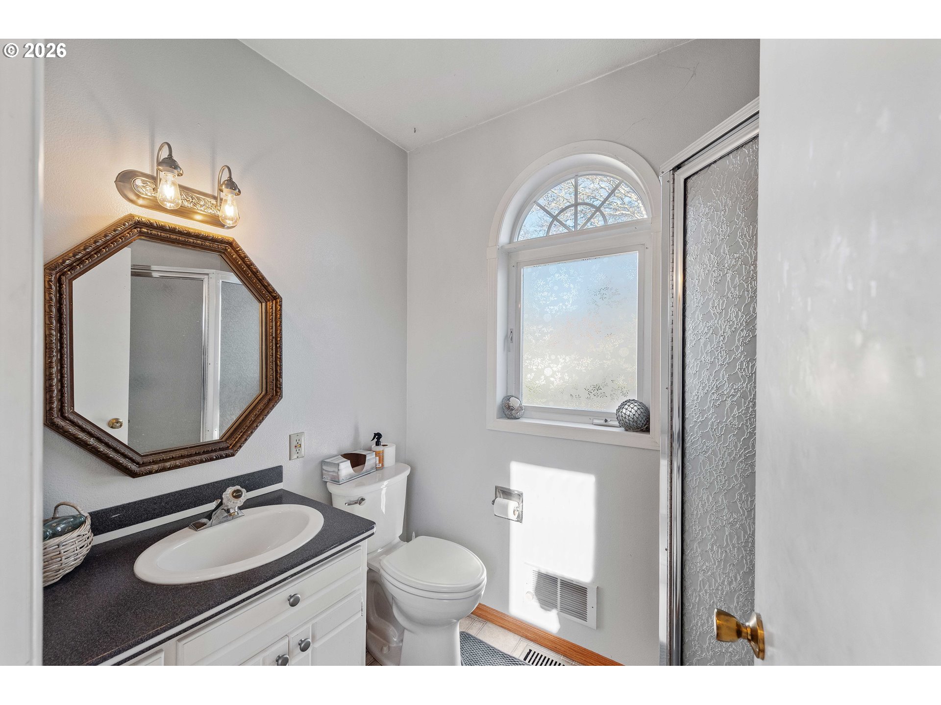 770 18th Avenue Coos Bay, OR 97420 - Photo 25 of 48 a bathroom with a toilet sink vanity granite and mirror