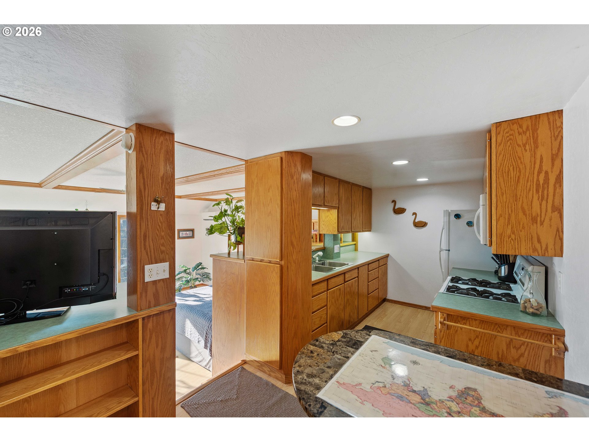 770 18th Avenue Coos Bay, OR 97420 - Photo 30 of 48 a open kitchen with stainless steel appliances kitchen island granite countertop a refrigerator and a stove top oven
