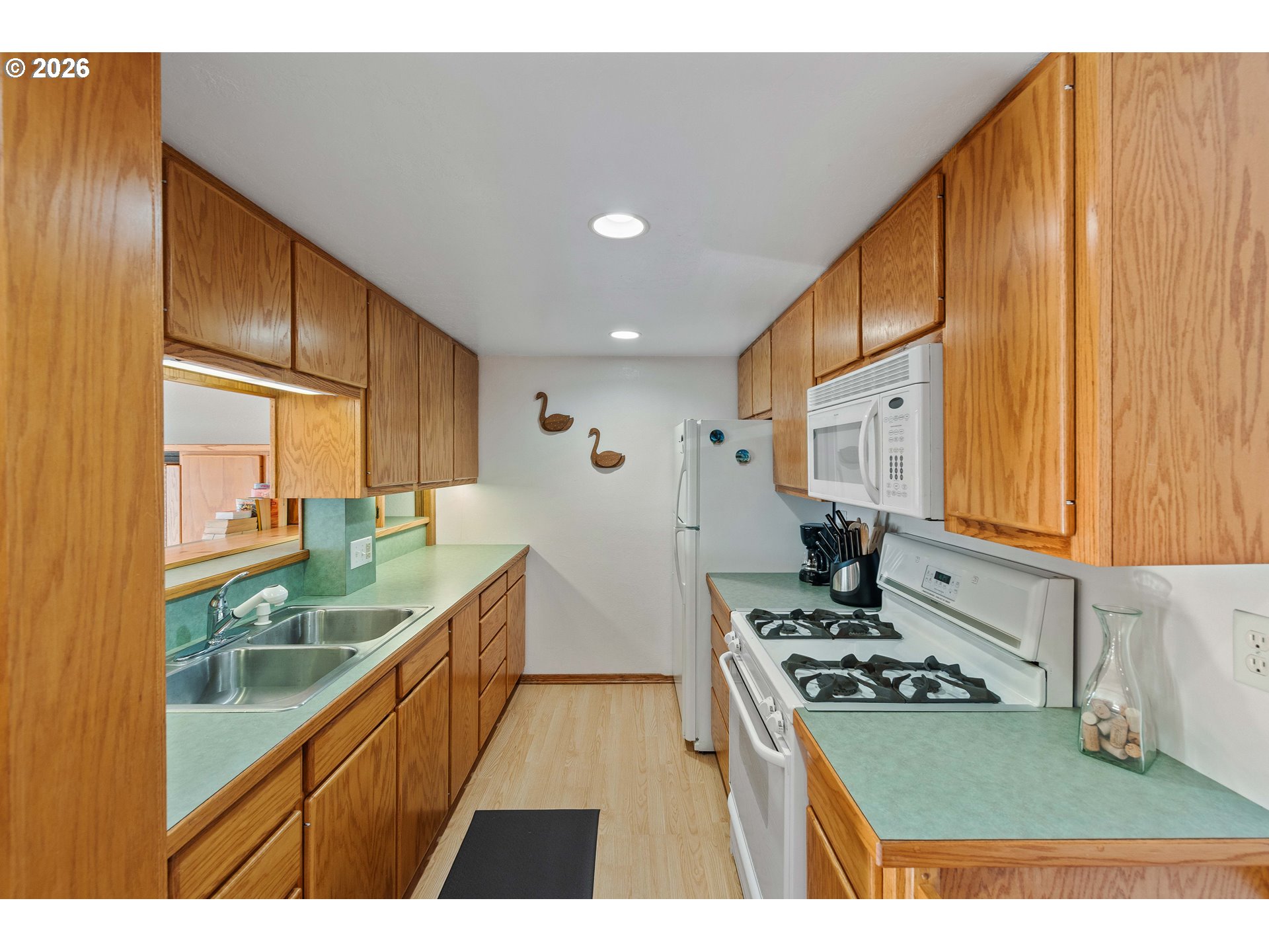 770 18th Avenue Coos Bay, OR 97420 - Photo 31 of 48 a kitchen with stainless steel appliances a stove a sink and a refrigerator