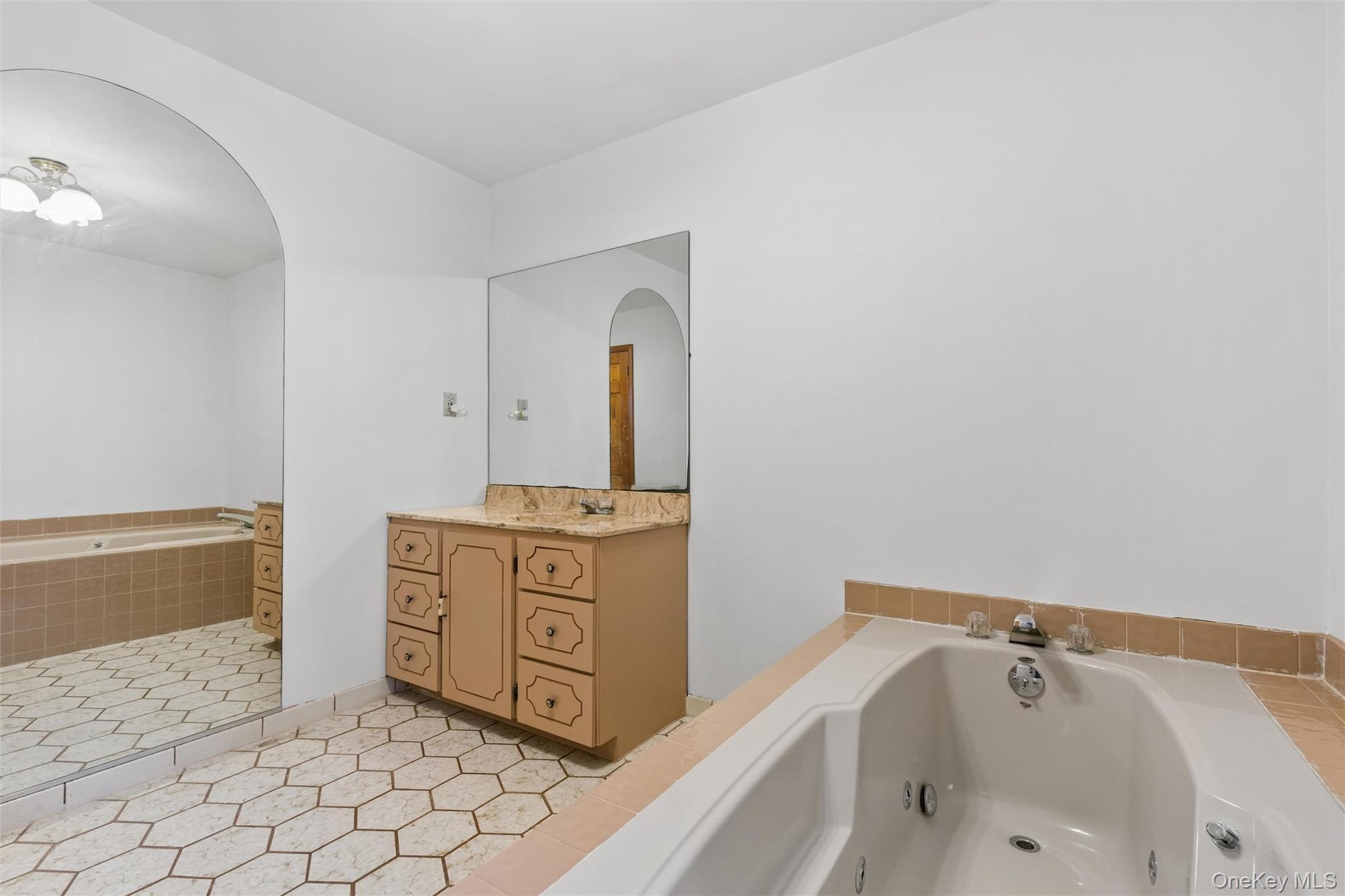 49 Overhill Road Wading River, NY 11792 - Photo 15 of 27 a spacious bathroom with a tub sink and mirror