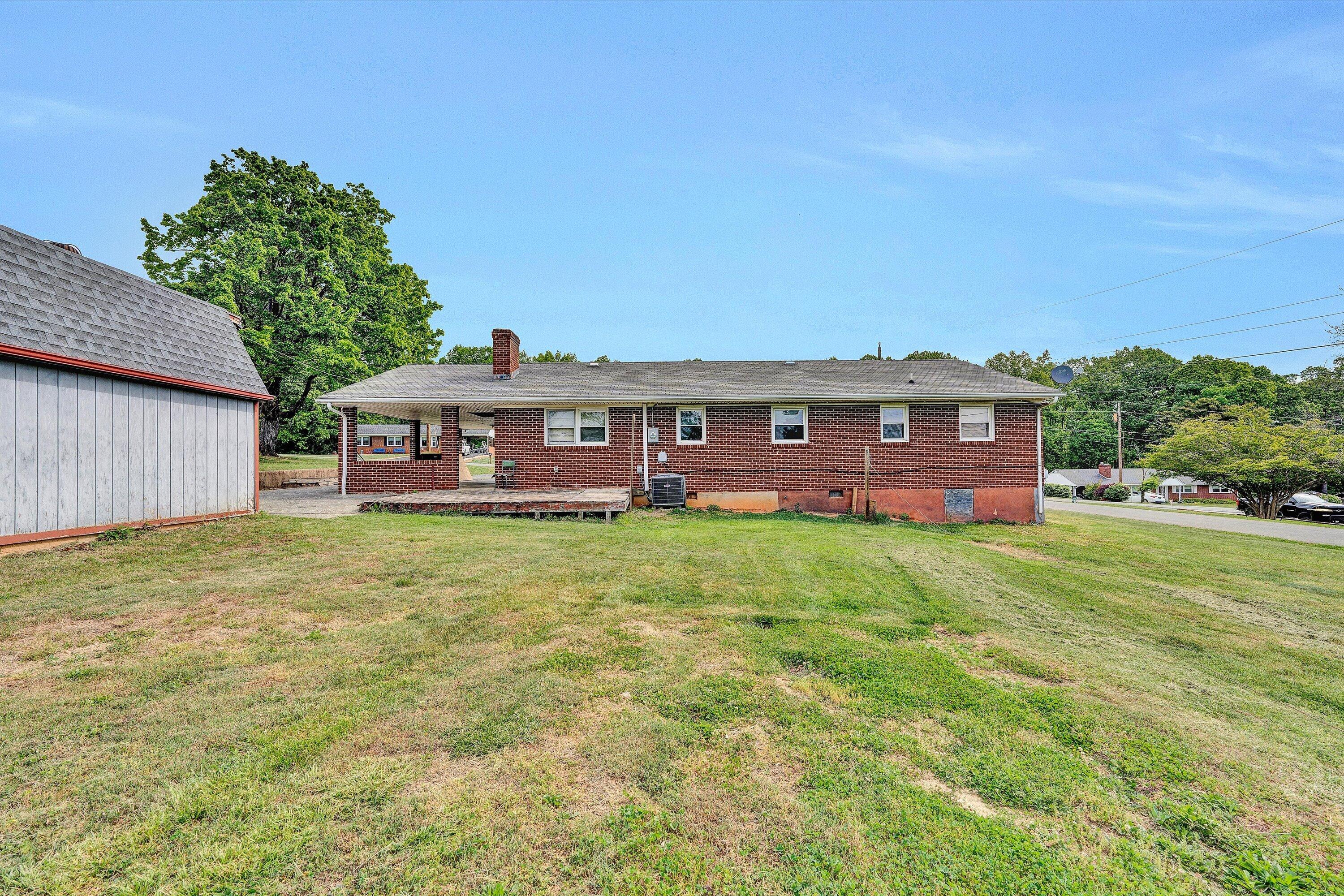 145 Cornell Road Rocky Mount, VA 24151 - Photo 14 of 16 a front view of a house with a garden and deck