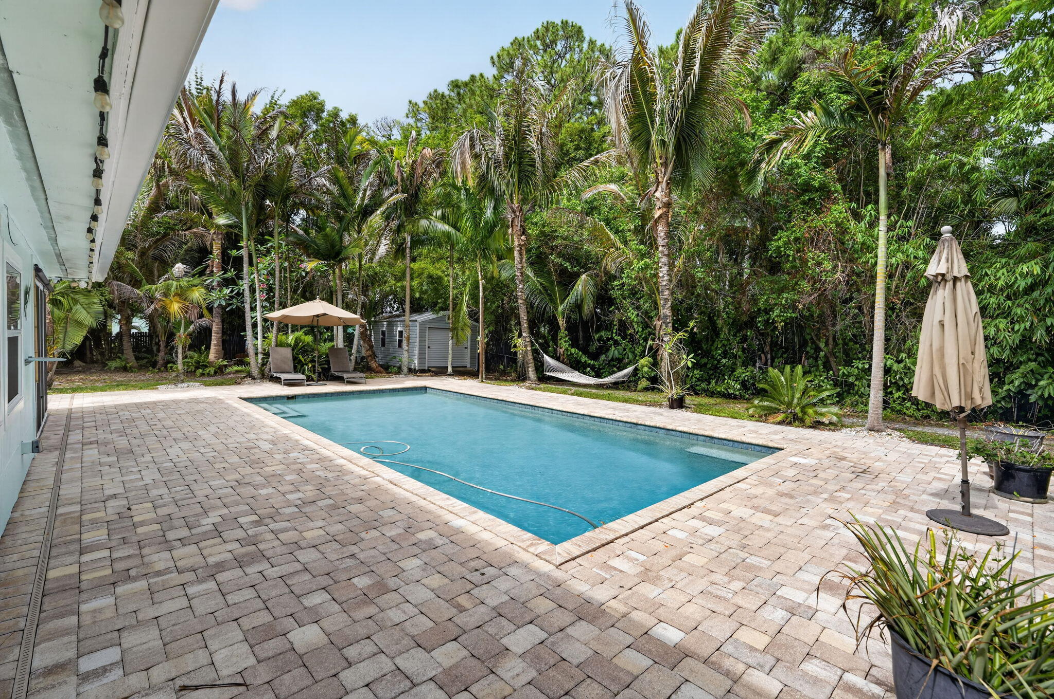 17391 Alexander Run Jupiter, FL 33478 - Photo 40 of 55 a view of a swimming pool with a patio