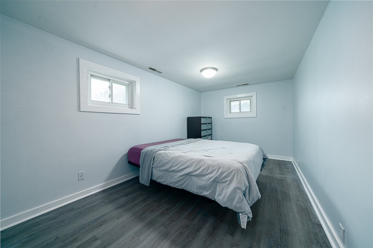 8424 South Main Street Rochelle, IL 61068 - Photo 19 of 26 a bedroom with a bed and wooden floor