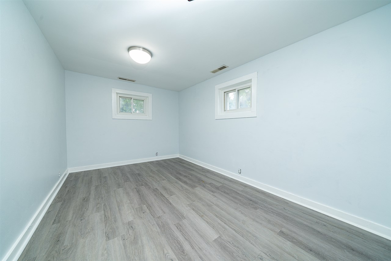 8424 South Main Street Rochelle, IL 61068 - Photo 21 of 26 an empty room with wooden floor and windows