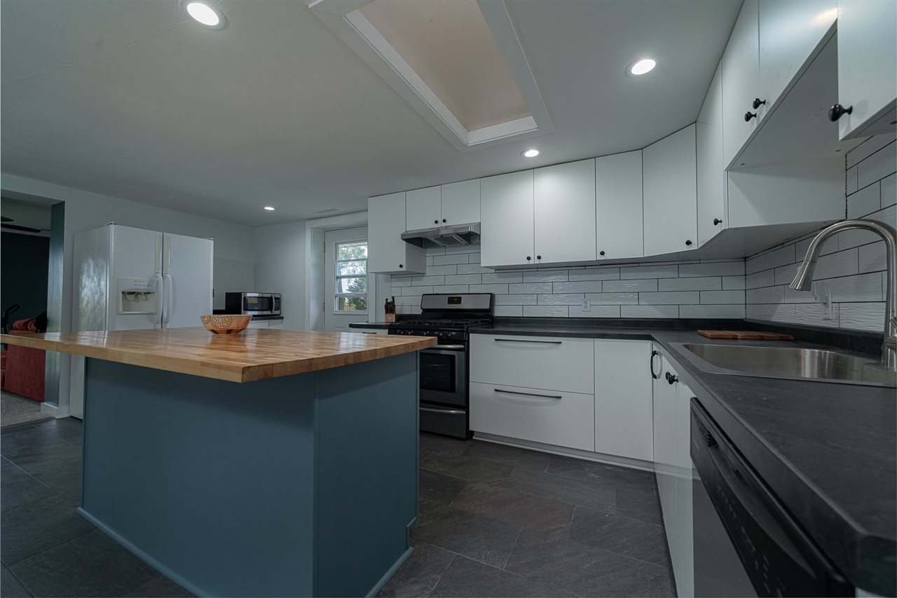 8424 South Main Street Rochelle, IL 61068 - Photo 10 of 26 a kitchen with stainless steel appliances granite countertop a sink stove and cabinets