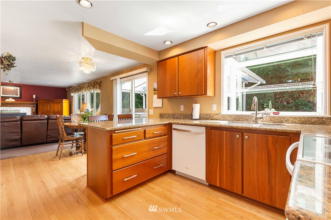 1508 243rd Place Southeast Bothell, WA 98021 - Photo 11 of 32 a kitchen with stainless steel appliances granite countertop a sink stove and cabinets
