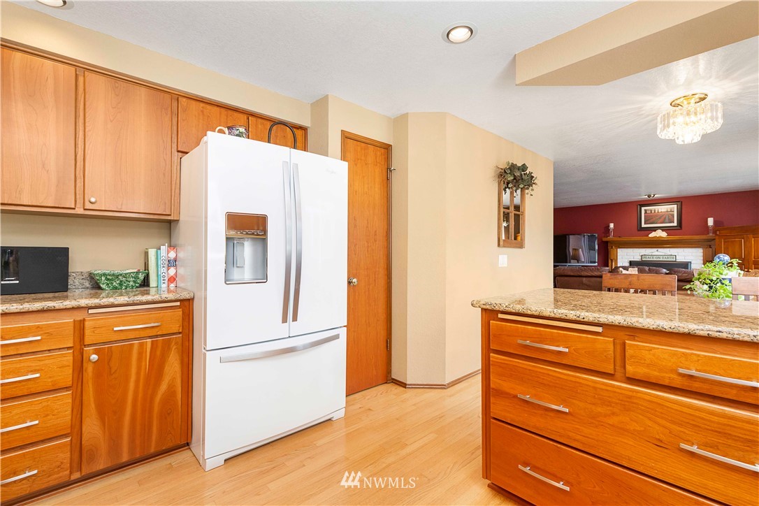 1508 243rd Place Southeast Bothell, WA 98021 - Photo 12 of 32 a kitchen with stainless steel appliances granite countertop a refrigerator and a stove