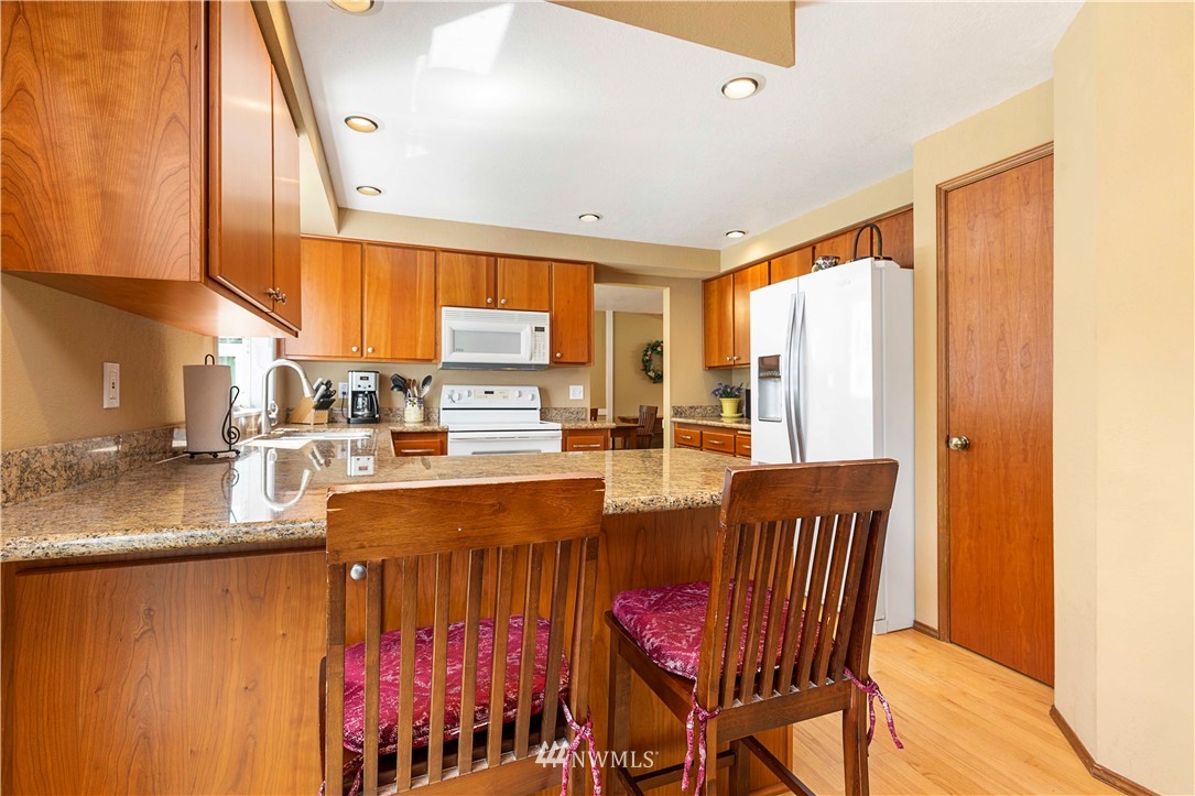 1508 243rd Place Southeast Bothell, WA 98021 - Photo 13 of 32 a view of a dining room with furniture and a chandelier