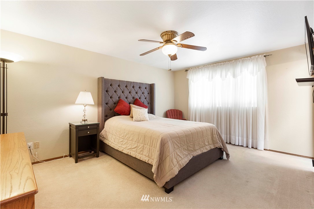 1508 243rd Place Southeast Bothell, WA 98021 - Photo 20 of 32 a bedroom with a bed and a chandelier