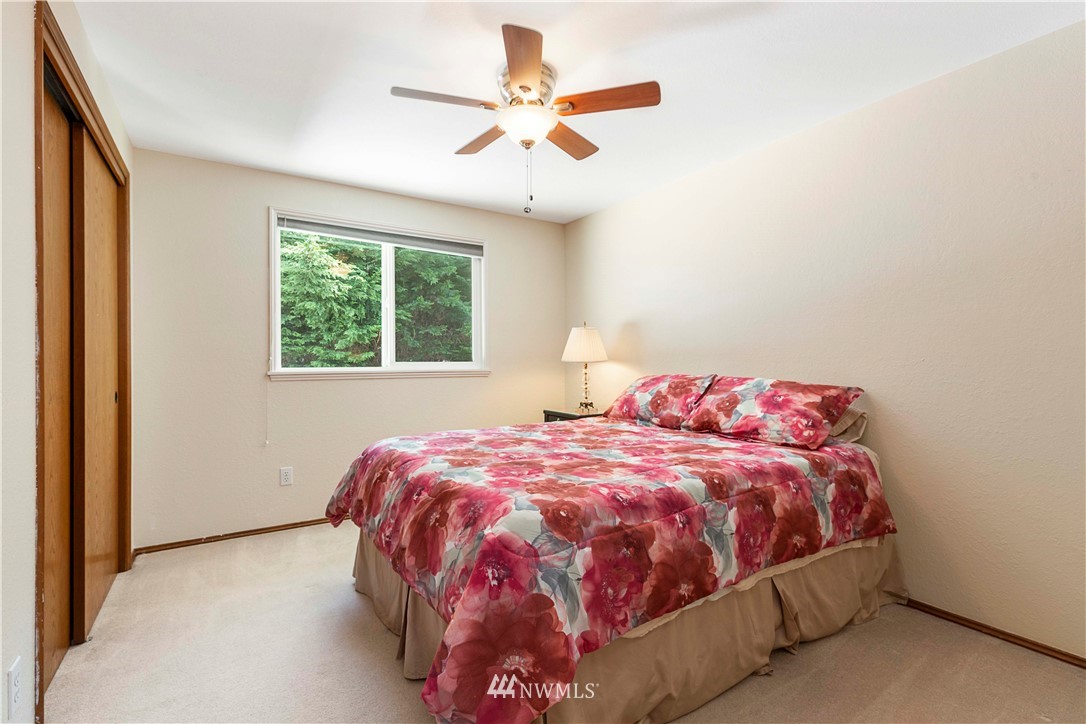 1508 243rd Place Southeast Bothell, WA 98021 - Photo 22 of 32 a bedroom with a bed and a chandelier