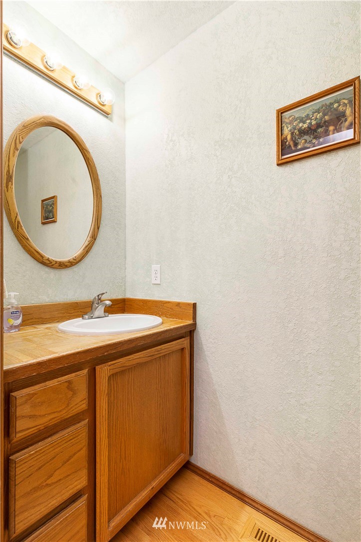 1508 243rd Place Southeast Bothell, WA 98021 - Photo 26 of 32 a bathroom with a granite countertop sink and a mirror