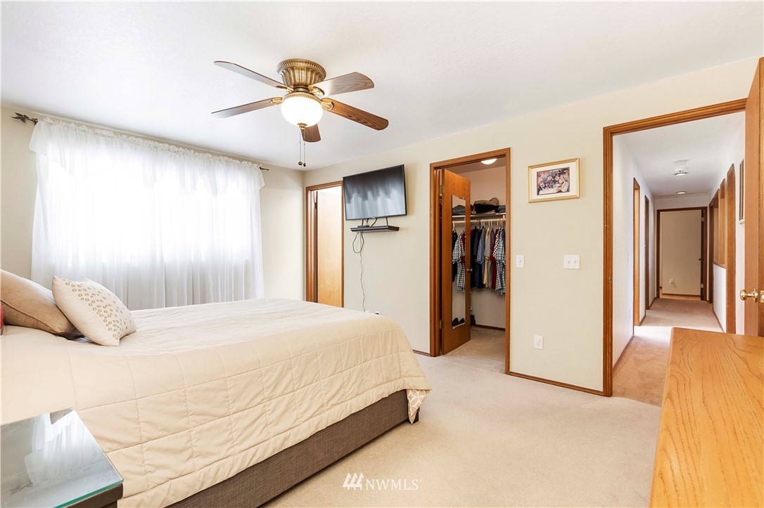 1508 243rd Place Southeast Bothell, WA 98021 - Photo 27 of 32 a bedroom with a large bed closet and a window