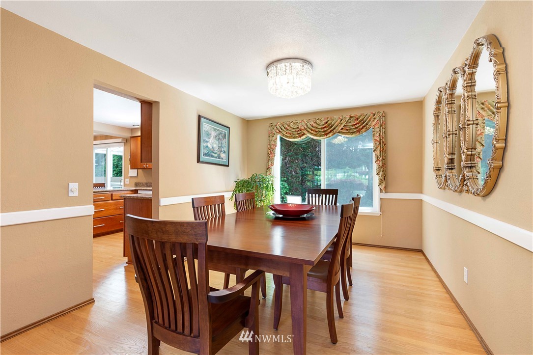1508 243rd Place Southeast Bothell, WA 98021 - Photo 9 of 32 a view of a dining room with furniture window and wooden floor