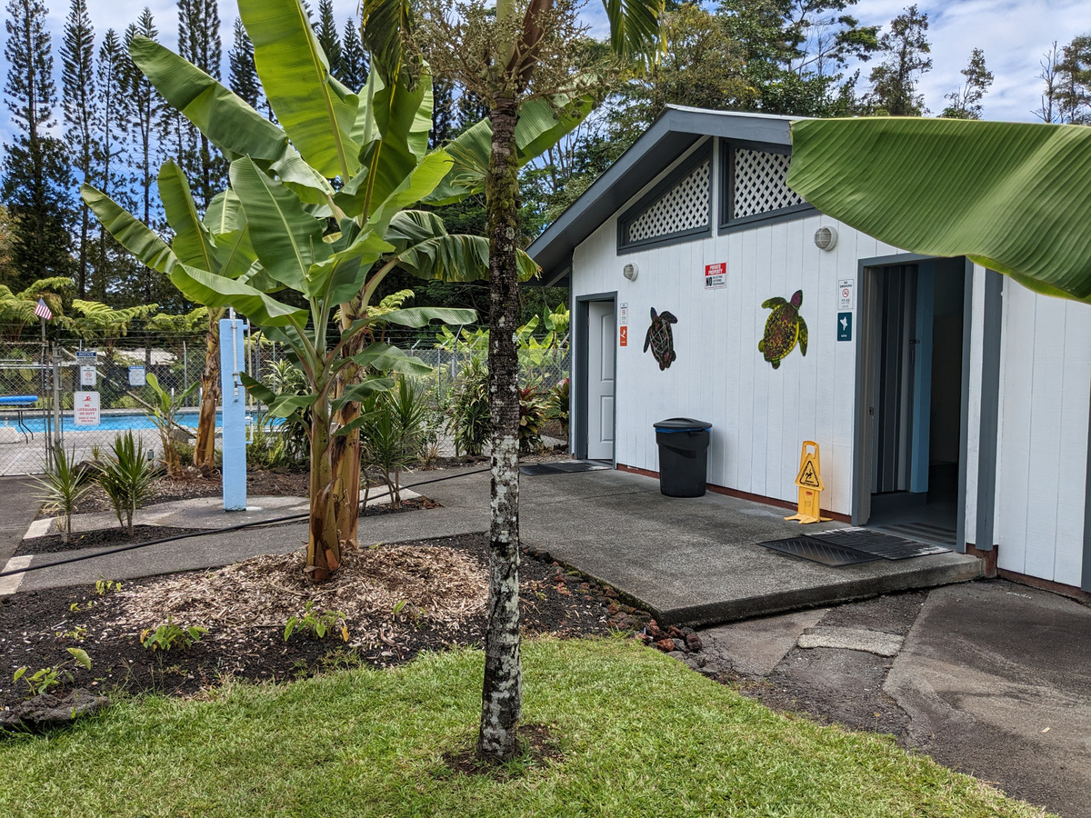 785 Pahoa Road Pahoa, HI 96778 - Photo 17 of 20 a view of a white house with a small yard and large tree
