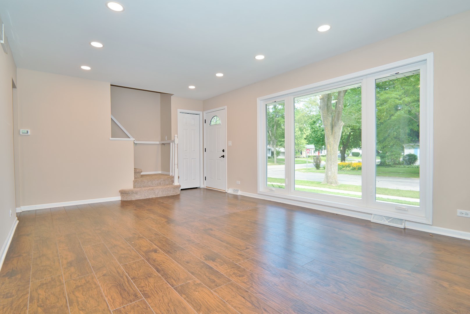 378 Glendale Road Buffalo Grove, IL 60089 - Photo 2 of 23 a view of an empty room with wooden floor and a window