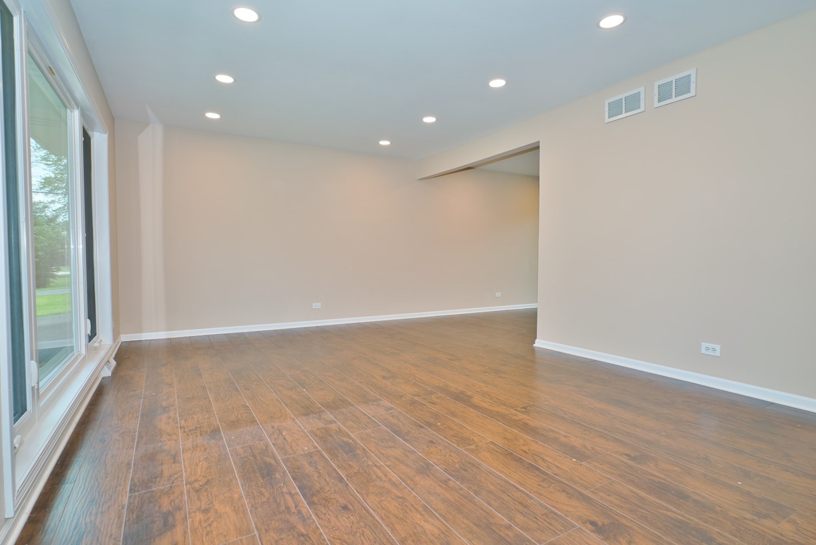 378 Glendale Road Buffalo Grove, IL 60089 - Photo 3 of 23 an empty room with wooden floor and windows